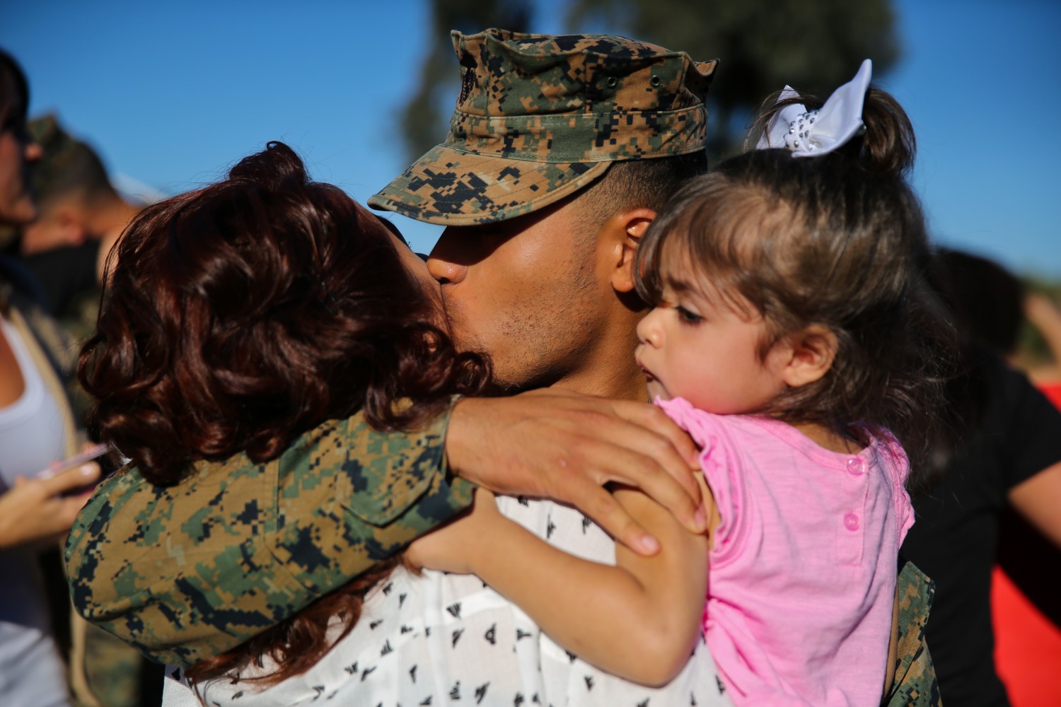 US Marine holds two young daughters
